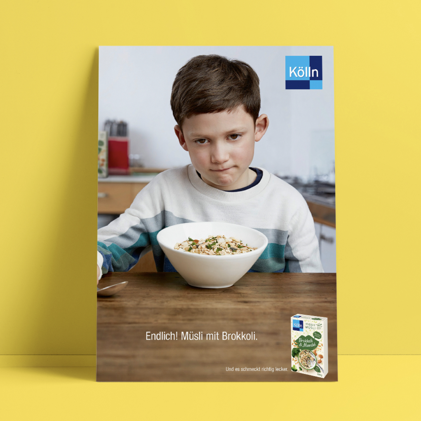 Sad boy is sitting in front of a muesli bowl in the kitchen