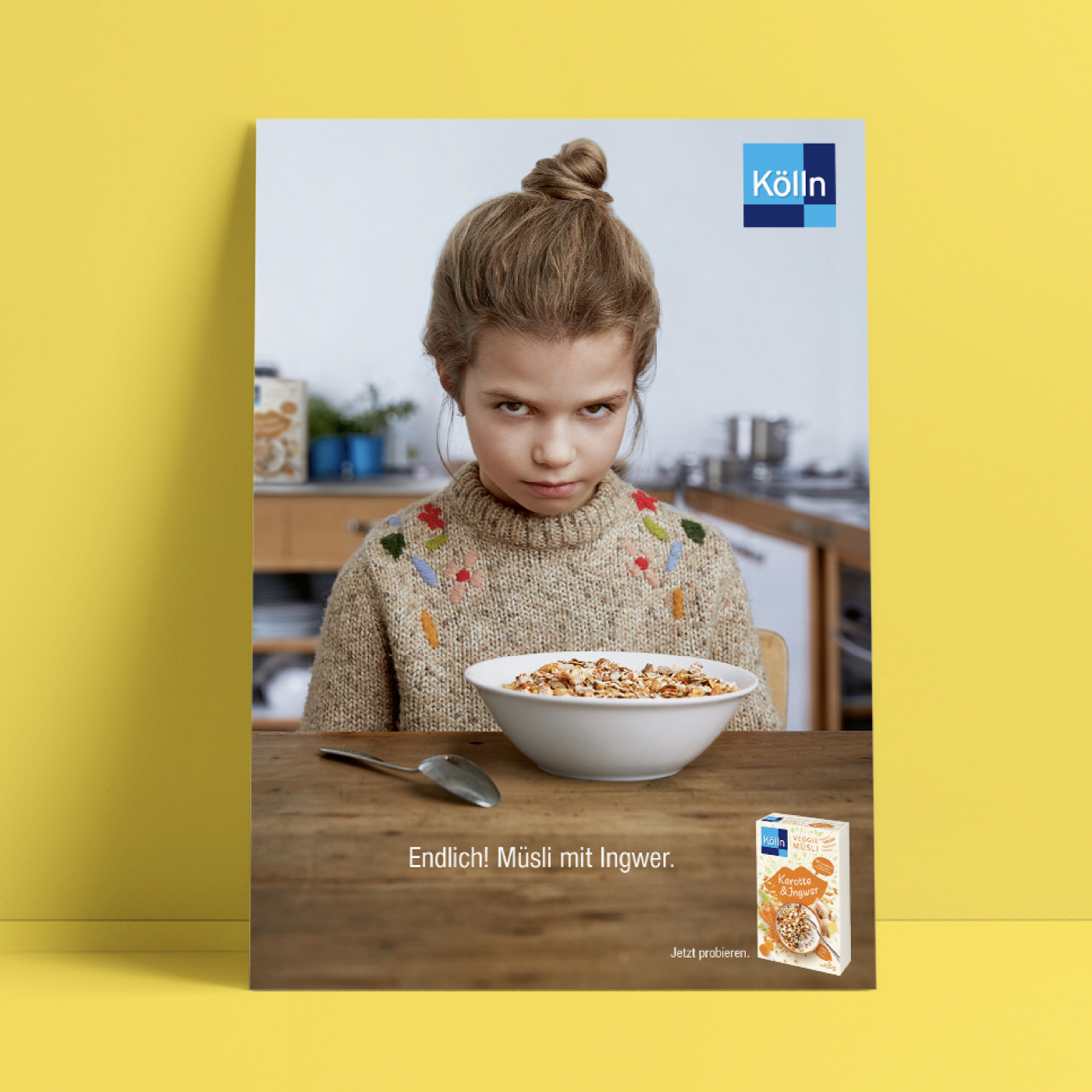 Grumpy girl is sitting in front of a muesli bowl in the kitchen