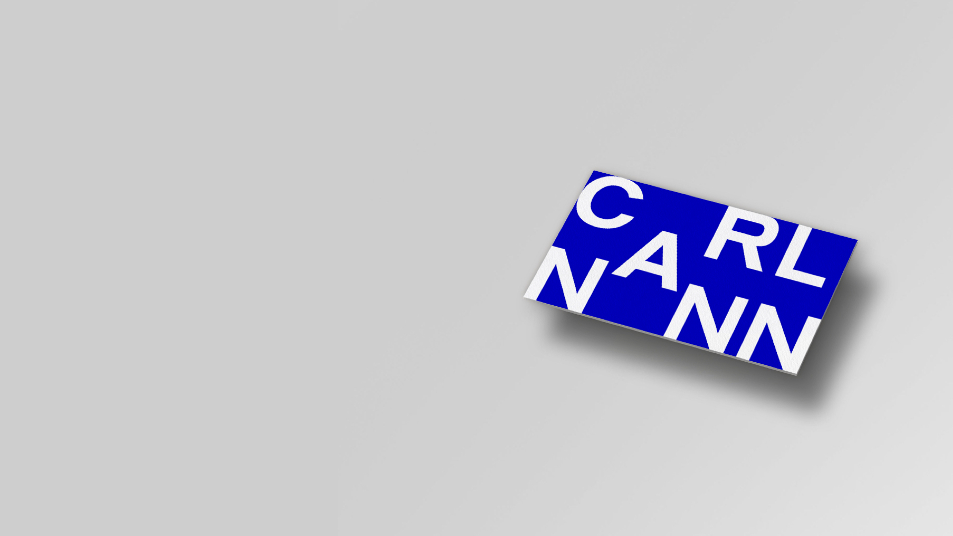 White CarlNann Logo on blue square on grey background