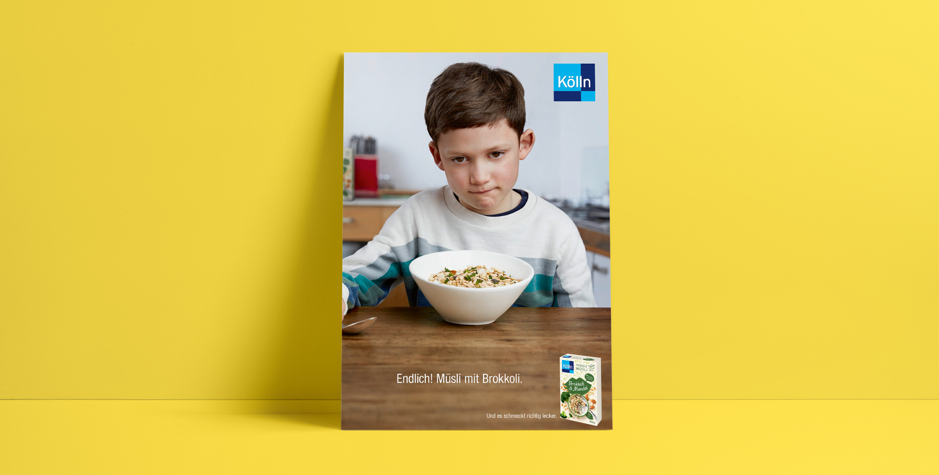 Sad boy is sitting in front of a muesli bowl in the kitchen