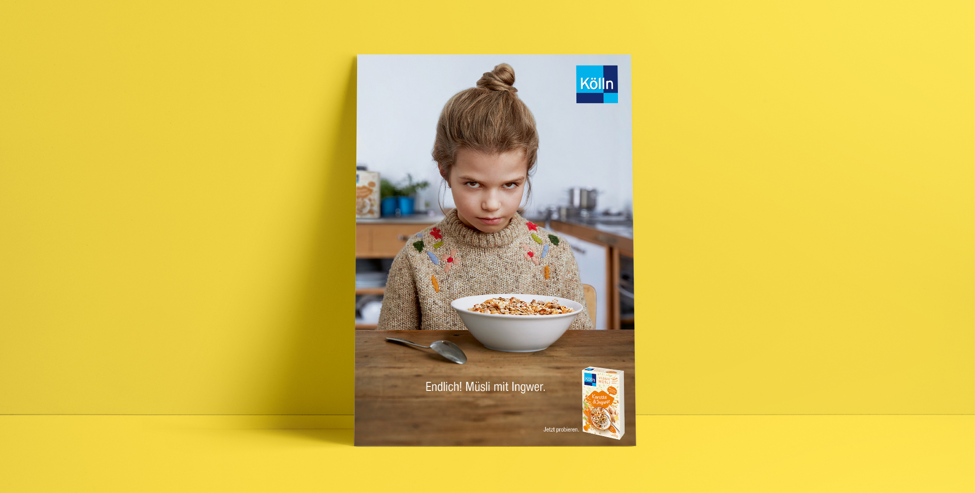 Grumpy girl is sitting in front of a muesli bowl in the kitchen