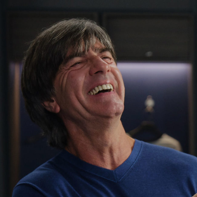 Jogi Löw wearing blue shirt and laughing